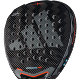 A close-up of the Adidas Metalbone HRD+ 3.4 Ale Galan 2025 padel racket reveals its textured surface with circular holes, designed for offensive players. Red and blue accents border the METALBONE HRD print, emphasizing its customizability. The handle is partially visible at the bottom.