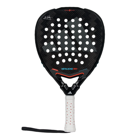 The Adidas Metalbone HRD+ 3.4 Ale Galan 2025 padel racket features a perforated black surface with red accents. Tailored for offensive play, its handle includes a white grip with red dots, allowing match customization.