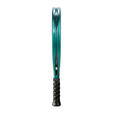 Side view of a teal tennis racket, the BULLPADEL RACKET HACK 04 2025 by Padel Smash Academy. It features Total Channel tech for enhanced play, a black textured-pattern grip for secure handling, and DUNLOP adorning the frame design.