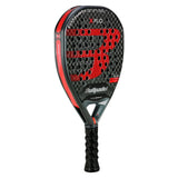 The BULLPADEL RACKET XPLO 2025 MARTÍN DI NENNO (LIKE NEW) from Padel Smash Academy features a bold black and red design with the Bullpadel logo on the face, a perforated surface, and textured grip handle for enhanced performance and style.