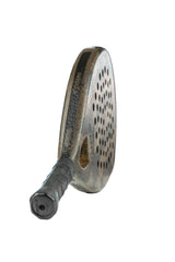 Close-up of the Cork Padel Extreme Black paddle, highlighting its high-performance design with a perforated oval head and textured grip handle, set against a plain white background.