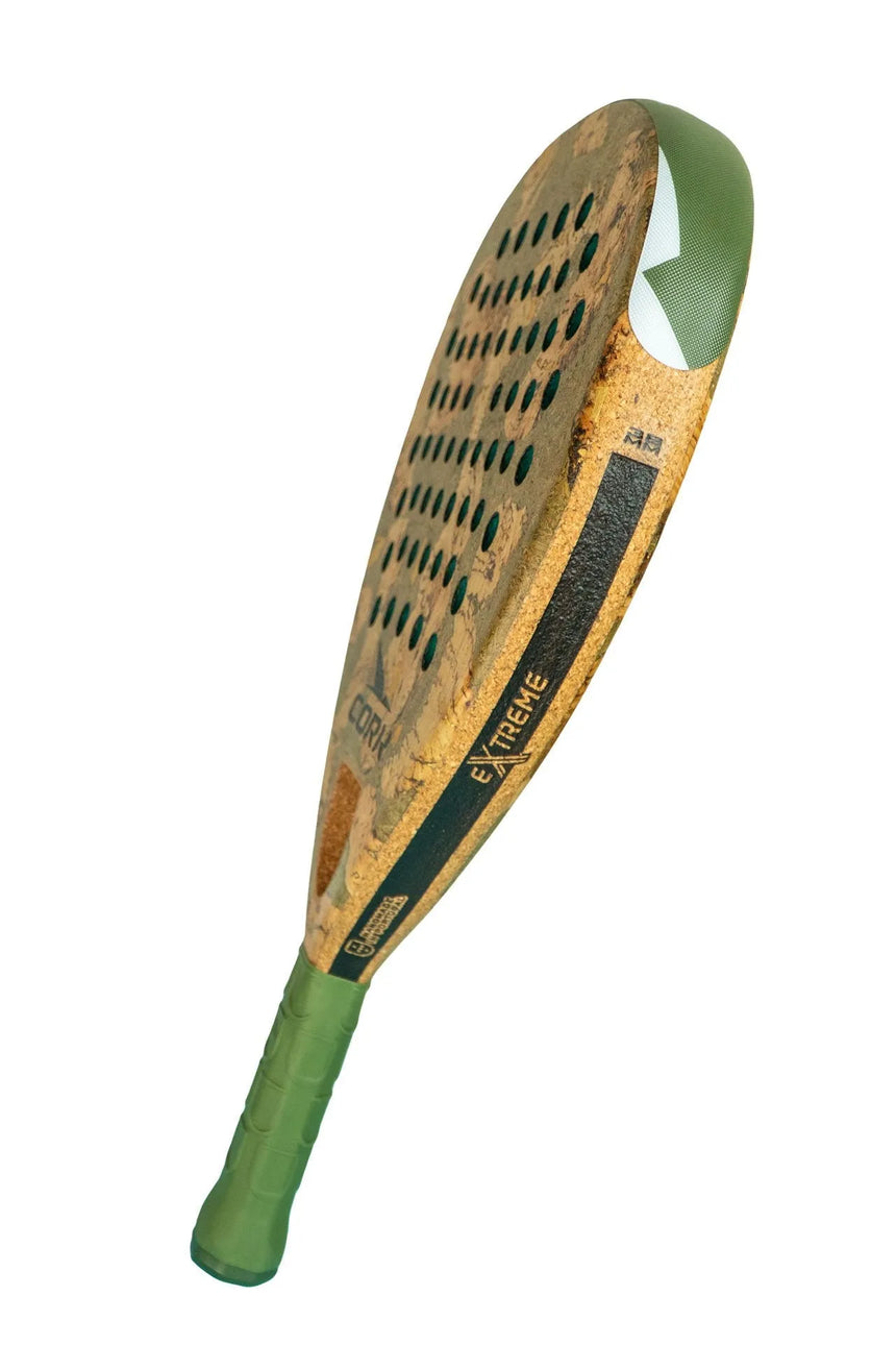 The Cork Padel Extreme Green racket is depicted at an angle, highlighting its perforated face and sleek textures. Its green grip tape complements the EXTREME branding, emphasizing this limited edition model popular among pros.