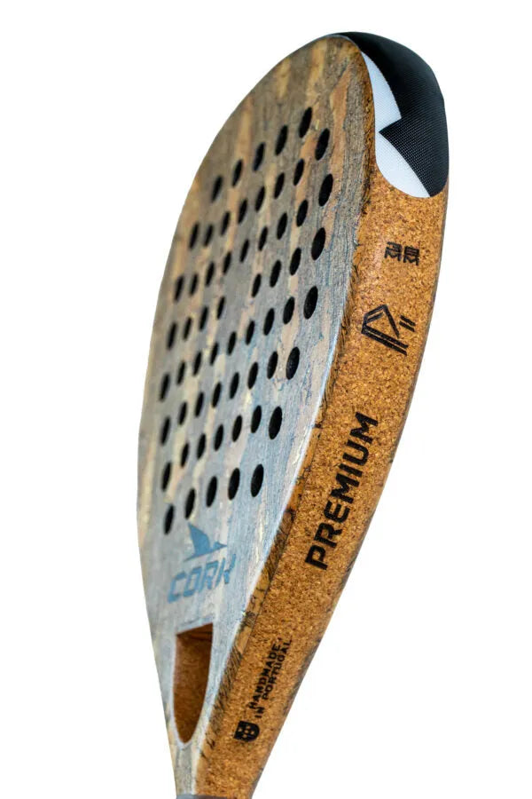 Close-up of the Cork Padel Premium Power II, crafted for advanced to professional players. Its cork-textured, perforated surface enhances aerodynamics, while the handle showcases branding similar to the Premium Power II Racket, perfect for offensive play.