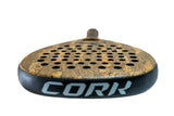 Close-up of the Cork Padel Premium Power II, crafted for advanced to professional players. This racket boasts a cork surface with circular cutouts, an extended handle, and CORK on its black edge—perfect for offensive players desiring precision and power.