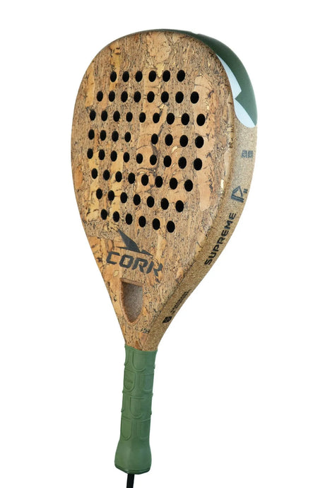 The Cork Padel Supreme Power III racket is designed for offensive players, crafted with a High Carbon Composition. It features a cork surface accented in green, a patterned grip, and perforations on the face. The branding text elegantly adorns the edges against a pristine white background.