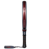 The NOX Padel Racket AT10 Genius 12K by Agustin Tapia 2025, with a red frame and black grip, is shown vertically on a white background. It features Exclusive Spin Technology and has Nox visible on the frame and cord, indicating precision and power in every swing.