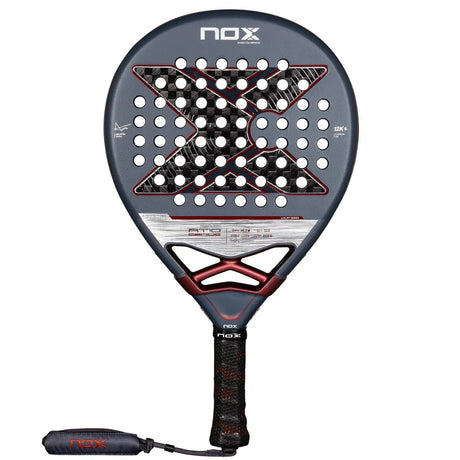 The NOX Padel Racket AT10 Genius 12K by Agustin Tapia 2025 features an X-shaped design in black, gray, and maroon. It includes Exclusive Spin Technology for enhanced control, with a textured grip handle and black-red strap.
