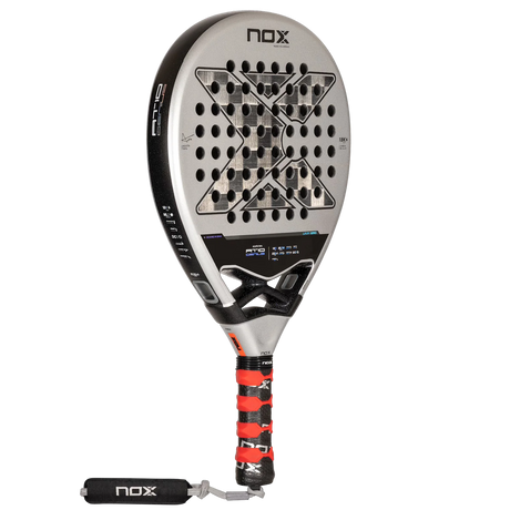 The NOX Padel Racket AT10 Genius 18K by 2024 Agustin Tapia features a sleek black and silver design, a bold X at the core, and a tricolor grip with wrist strap. Made from aluminized carbon fiber and incorporating EOS Flap technology, it proudly displays the NOX signature.