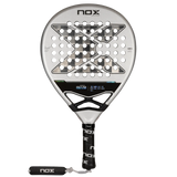 The NOX Padel Racket AT10 Genius 18K by 2024 Agustin Tapia features a circular head with a geometric hole pattern, crafted from aluminized carbon fiber for durability. Its gray and black design matches the handle, wrapped in a black grip with NOX branding.