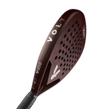 The dark red VOLT 950 V23 padel racket by Volt features a grid pattern of holes for power and control, tailored for advanced players. The brand name and model number appear in white on the surface, paired with a sleek black handle.